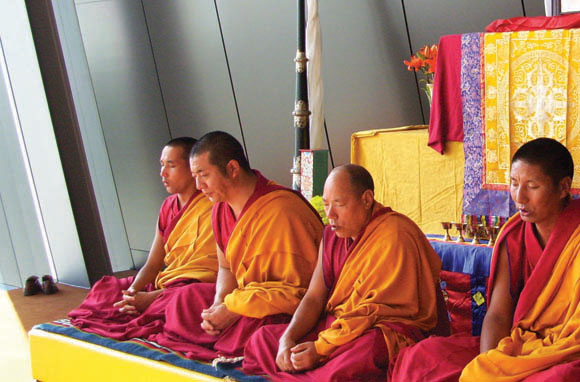 Buddhist monks perform an opening chant before a workshop.