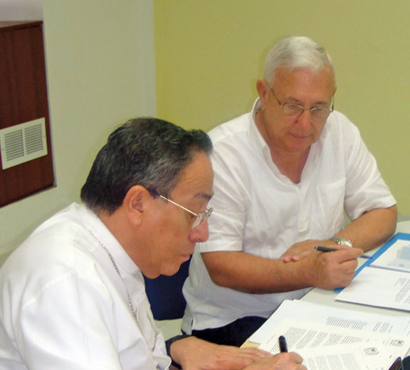 Cardinal Oscar Rodriguez of Honduras, President of the new ICI Board, with Fr. Jack Lynch, signing the transfer of responsibilities of ICI.
