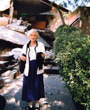 Above: Sr. Mary Alban Bouchard of the Sisters of St. Joseph stands in front of her severely damaged home.