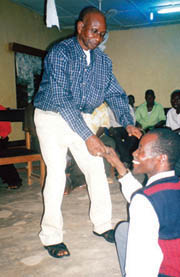 (Credit: Suzanne Marshall, O.L.M.) Theodore dances with Iorshee, a paraplegic, at a party celebrating Theodore’s retirement after 40 years of service to the St. Joseph Rehab Centre and to Our Lady’s Missionaries in ministry there. Nigeria.