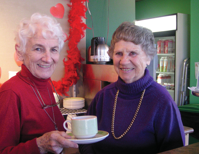 Volunteers Sister Noreen Kearns with her friend Eliza Landry work in the coffee and gift shop of a neighbourhood seniors residence. Noreen also does pastoral visiting in the long-term nursing unit.