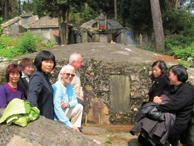 Members of the Catholic community in Lishui accompany lay missioner Louise Malnachuk and Fr. Mike Traher at the grave of Fr. Paul Kam (photo above left), the first seminarian of the China Mission Seminary (precursor to Scarboro Missions).