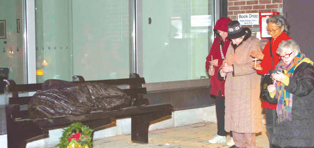 Our Lady’s Missionaries and participants of the Eucharistic Celebration of Social Justice last November at Regis College, Toronto School of Theology, take part in a candlelight vigil to recognize the city’s homeless. They gathered in front of the college at the statue of the Homeless Jesus, the work of sculptor Timothy Schmalz.