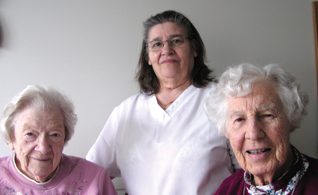 Sisters Elaine MacInnes (left) and Mary Hughes with Maria (centre), staff person and friend, at the OLM central house in Toronto.